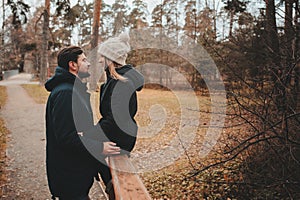 Loving young couple happy together outdoor on cozy warm walk in autumn forest