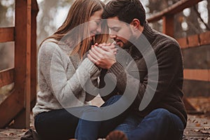 Loving young couple happy together outdoor on cozy warm walk in forest