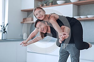 Loving young couple having fun in their kitchen.