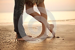 A loving young couple hugging and kissing on the beach. Lovers m