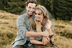 Loving young couple hugging and smiling together on nature background