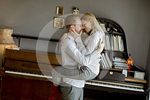 Loving young couple kissing in the room