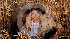 Loving Young Couple Kissing While Sitting In Wheat Field, Slow Motion Footage