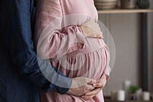 Loving young man and pregnant woman waiting for baby.