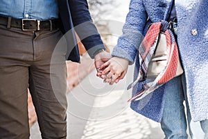 Loving young man and woman holding hands