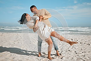 Loving young mixed race couple dancing on the beach. Happy young man and woman in love enjoying romantic moment while on