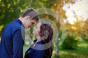 Loving young teenage couple hugging with eyes closed outdoors