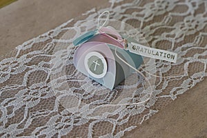 Lovingly wrapped small gift package for confirmation with ribbon and a lettering GRATULATION