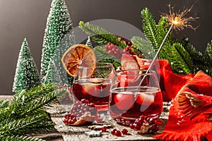 Low alcoholic cocktail with fruits syrup and ice. Sparklers, Christmas traditional decor, New Year