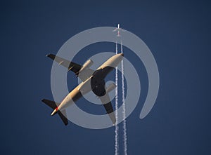 Low-Altitude and High-Altitude Airliners in Flight at Sunset