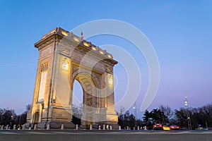 Low angle of Arch of Triumph Arcul de Triumf in Bucharest, Romania, at sunset, blue hour. photo