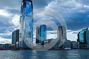 Low Angle Architectural View of Modern Glass Skyscrapers Featuring One World Trade Center Building Against Blue Sky