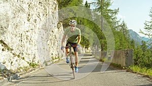 LOW ANGLE: Athletic man training for a cyclocross race in the sunny mountains.