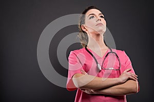 Low angle of attractive lady doctor posing with arms crossed