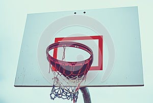 Low angle of basketball hoop with red white blue net