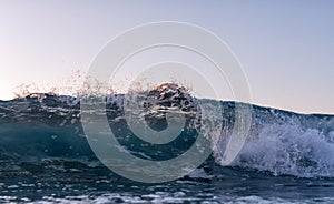 Low angle of a breaking wave in front of the camera