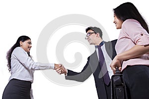 Low angle businesspeople handshaking