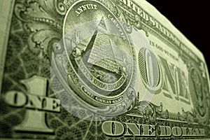 Low angle close up of the American dollar, focused on the eye of providence, at the top of the pyramid.