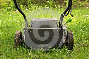 Low Angle Close up lawnmower ready to be cutting long grass or illustrating concept of helping bees
