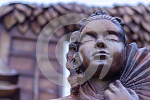 Low angle close up shot of a traditional Japanese woman statue with uchiwa hand fan.Buddhism concept