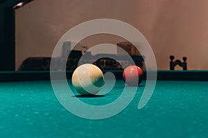 Low angle closeup shot of the white and the number three billiard balls on a table