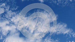 Low angle cloudscape time lapse. Fluffy clouds moving on the blue sky. Aerial composition, wind blowing changing mist shapes, abst