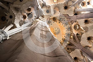 Low angle of a concrete stony column and decorated ceil with sunlight