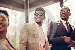 Low angle cropped view of guys with positive smiles watching the ceremony