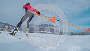 LOW ANGLE, DOF: Young woman prepares for the Olympic trials in Nordic skiing.