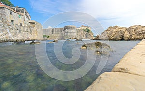 Low Angle of Dubrovnik's City Walls with Sunbathers photo