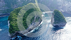 Low angle eerial view by drone camera at Nusa Penida, Indonesia. Ocean with waves and rocky cliff. Turquoise water