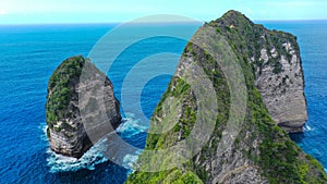 Low angle eerial view by drone camera at Nusa Penida, Indonesia. Ocean with waves and rocky cliff. Turquoise water