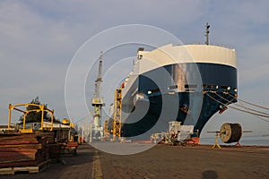 Low angle front view of a large Auto car carrier ship moored alongside in port