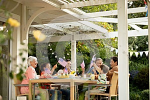 Family eating outside together in summer