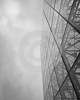 Low angle of a glass-walled building on a cloudy sky photo