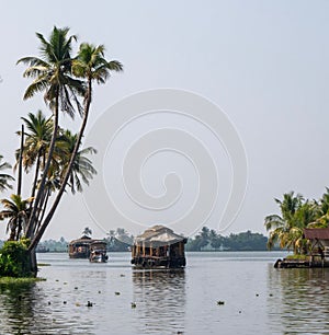 Low-angle of Indian bayous houseboats backwater tour karela against gloomy sky photo