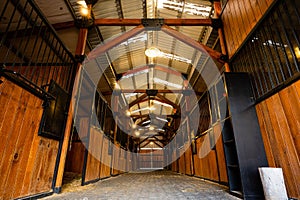 Low-angle of the interior of rustic wooden horse stables