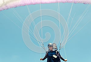 Low angle of male paraglider taking off