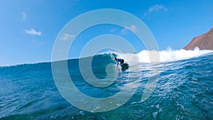 LOW ANGLE: Male surfer riding glassy wave on his fun surfboard in sunny Lobos.