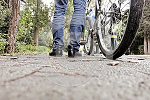 Low angle of a man with his bicycle