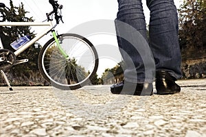Low angle of a man with his bicycle