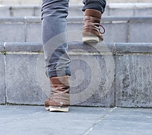 Low angle man walking up steps