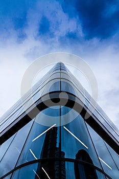 Low angle of a modern glass-walled building in Manchester, England photo