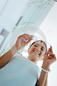 Low angle of a nice woman looking at the glasses