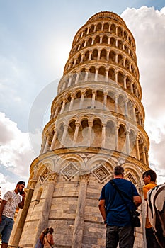 Low angle perspective view on the famous leaning Tower of Pisa or La Torre di Pisa at the Cathedral Square, Piazza del Duomo with