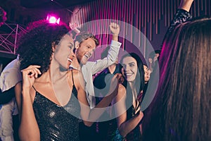 Low angle photo of young students company dancing at night club celebrating prom party together wearing festive clothes