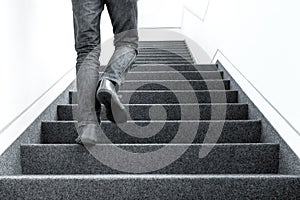 Low angle picture of man walking upstairs on indoors