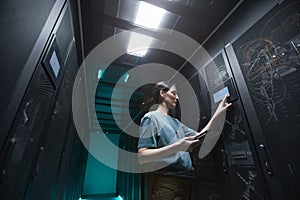 Female IT Technician Managing Server in Data Center