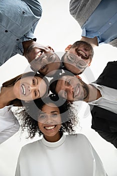Low angle portrait of smiling diverse employees together