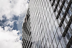 Low angle of the reflective Seagram Building against the cloudy sky photo